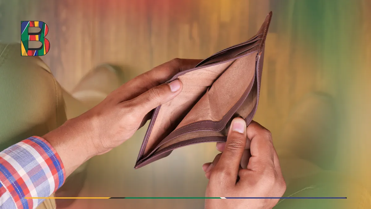 Person holding open an empty wallet with no cash inside.